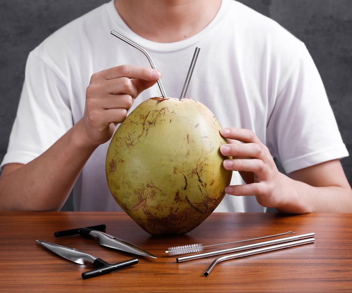 CJFocus green husk coconut being opened for fresh tropical water.