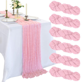CKIKU pink cheesecloth table runner drapes elegantly for weddings and celebrations.