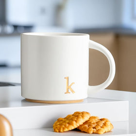 COLLECTIVE HOME elegant gold letters mug highlighting refined initials.