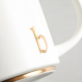 COLLECTIVE HOME monogram mug on a desk setting for an elegant workspace