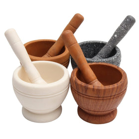 Comebuywide resin pestle and mortar in action crushing garlic and herbs.
