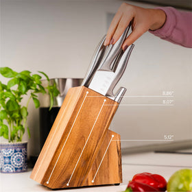 Coninx Acacia knife block on countertop supports easy reach while cooking.