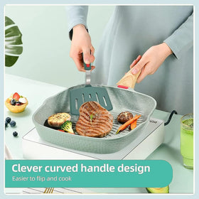 Dishwasher-safe Contiup spatula with silicone head and stainless steel core in green.