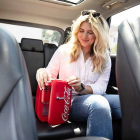 Cooluli Retro Coca-Cola Mini Fridge in a bedroom setup keeps beverages and cosmetics within reach.