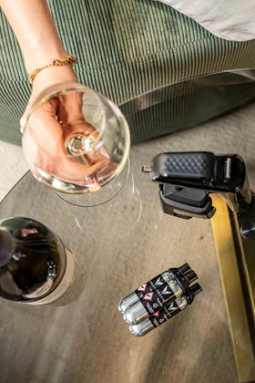 Capsules being inserted into a Coravin system for precise, safe pours.