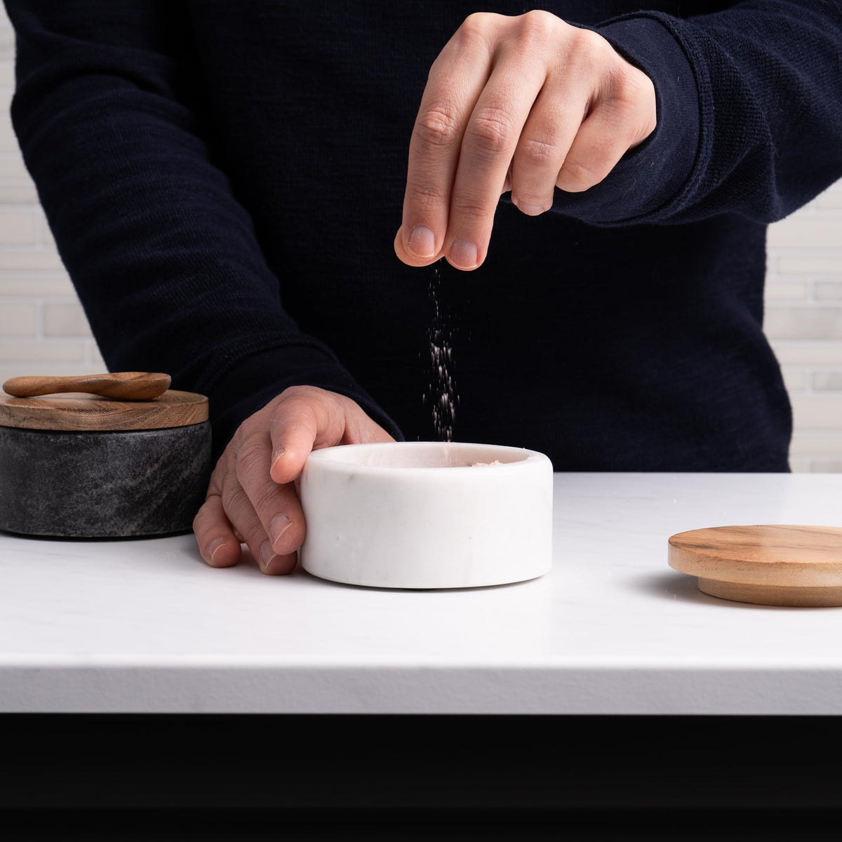 Cork & Mill acacia lid salt keeper shown with spoon, preserves flavor and prevents clumping.