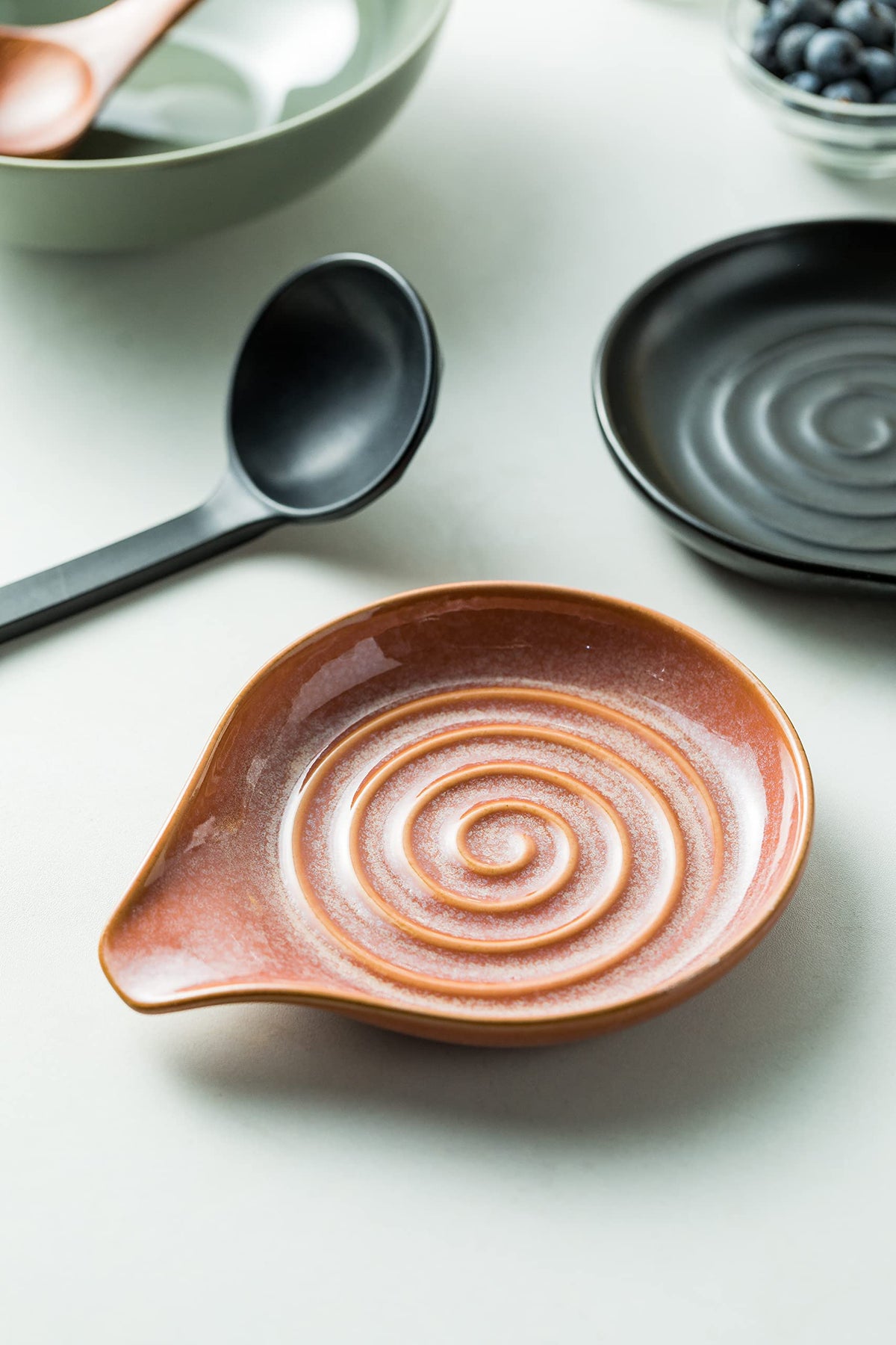 Reactive red glaze creates unique color patterns on each piece.