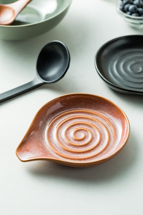Reactive red glaze creates unique color patterns on each piece.