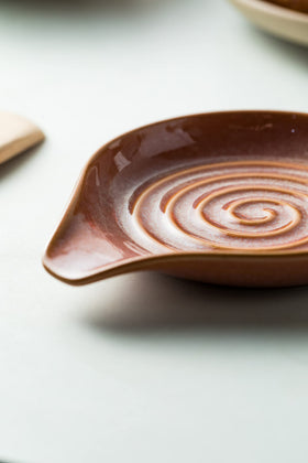 Elegant red glaze complements modern kitchen decor.