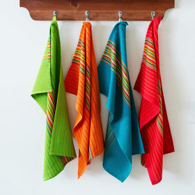Cotton Craft folded kitchen towels show soft fabric and durable weave.