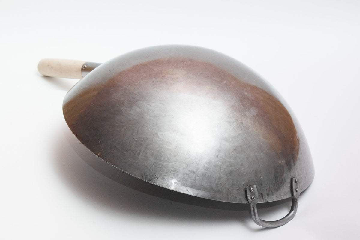 Craft Wok side handle closeup highlights robust build and heat-resistant grip.