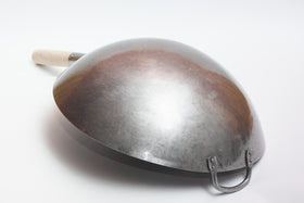 Craft Wok side handle closeup highlights robust build and heat-resistant grip.