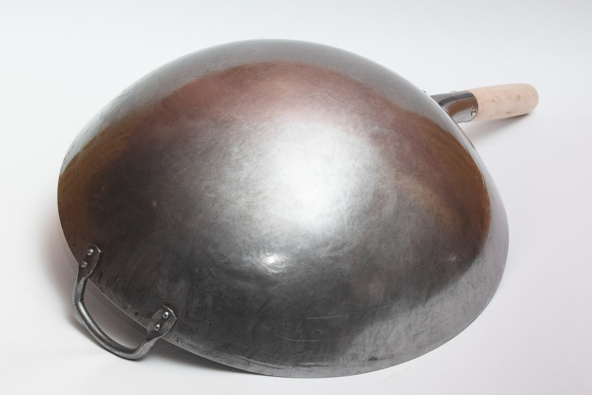 Craft Wok wooden and steel helper handle closeup emphasizes safe, stable stirring.