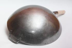 Craft Wok wooden and steel helper handle closeup emphasizes safe, stable stirring.