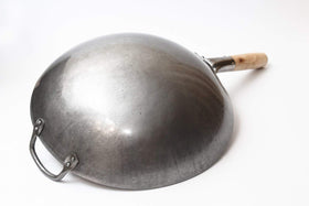 Close-up of hammered carbon steel surface showing craftsmanship and durability.