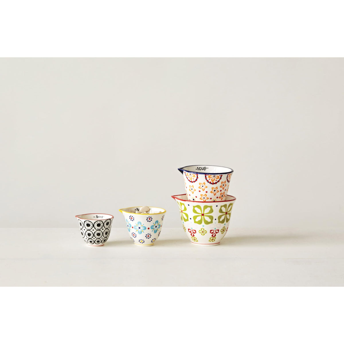 Creative Co-Op 1/2 cup floral stoneware stamp adds decorative utility for precise baking.