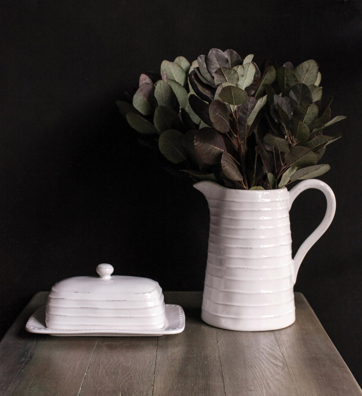 Creative Co-Op White Ceramic Pitcher with distressed finish adds rustic charm