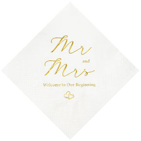 Crisky Mr and Mrs gold foil napkins decorate wedding reception table.