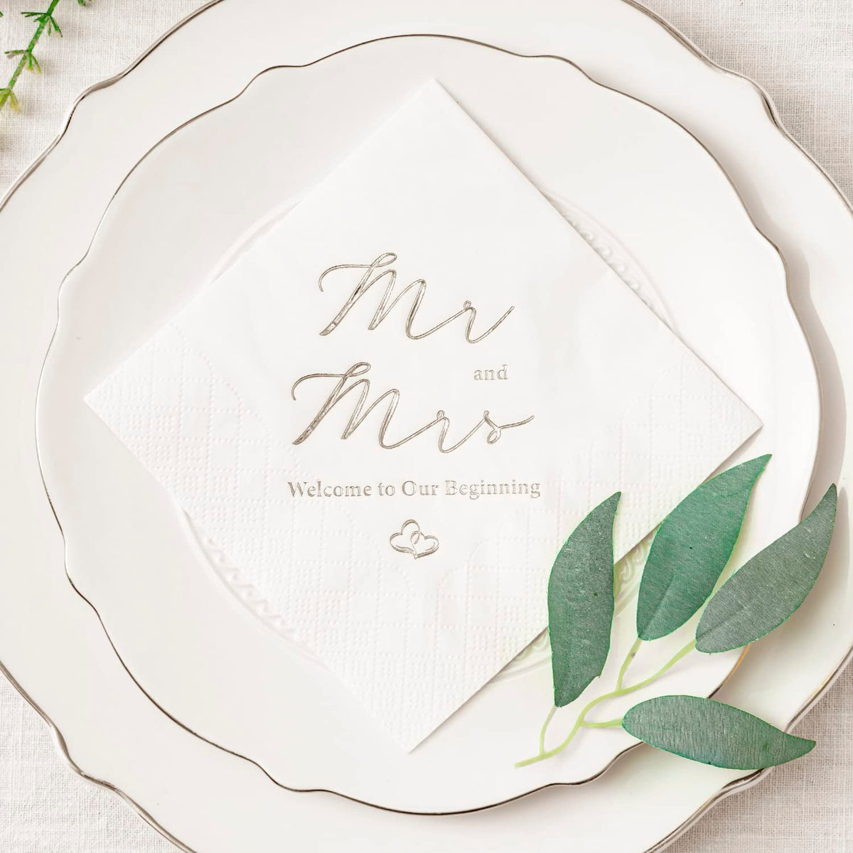 Crisky Mr and Mrs wedding napkins on a stylish table setting for reception.