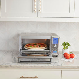 Cuisinart Chef's Convection Toaster Oven with pizza inside showing even browning potential.