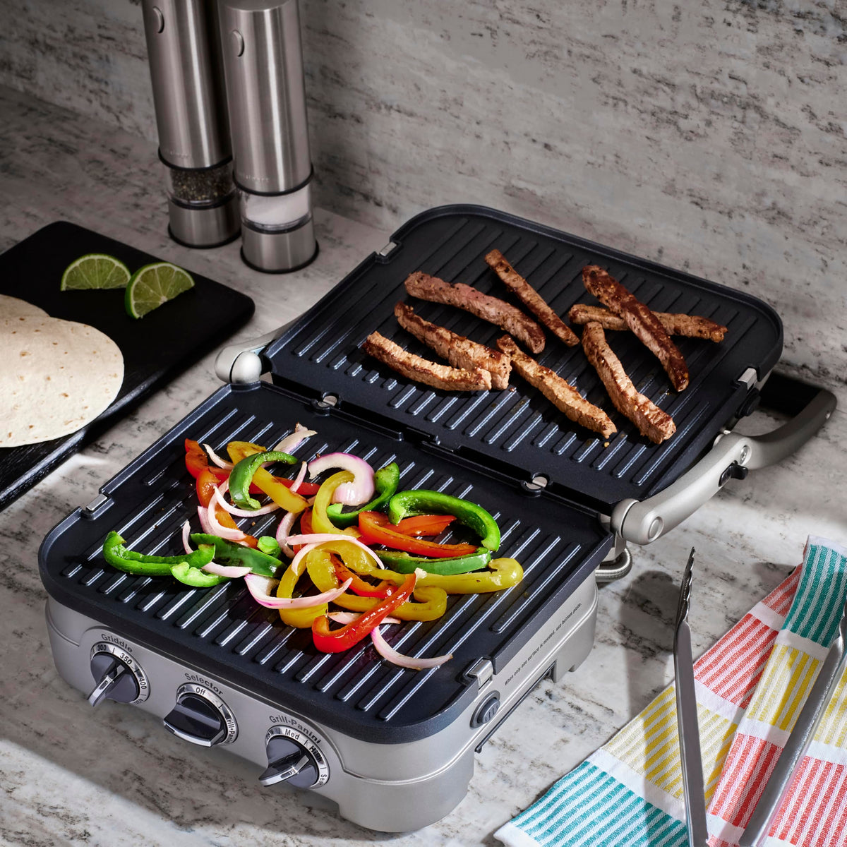 Cuisinart Griddler full grill mode searing steaks with grill marks.