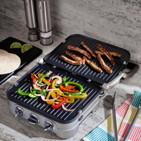 Cuisinart Griddler full grill mode searing steaks with grill marks.