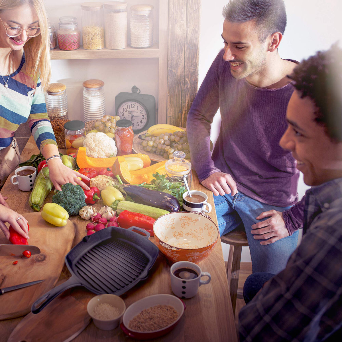 Cuisinel outdoor grilling scene with campfire and cast iron pan.