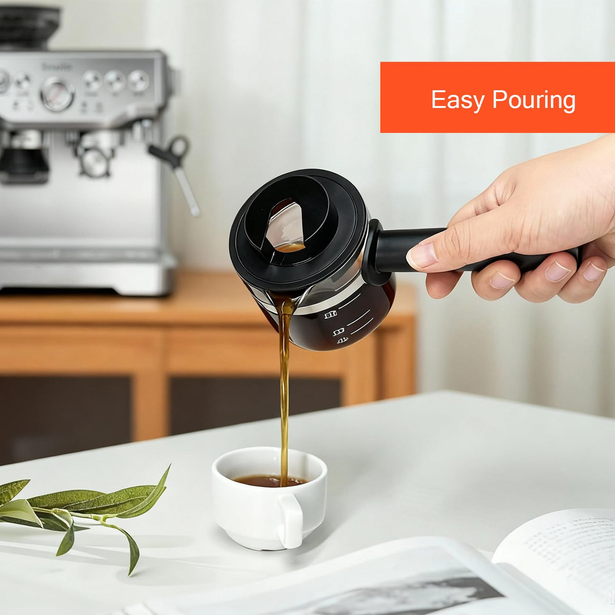 cupsync 4-cup carafe shown in use pouring fresh espresso into a cup
