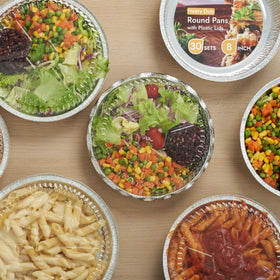 CURTA round pans with clear lids arranged for catering and takeout presentation.