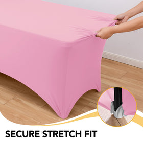 Reinforced leg pockets secure a Dailyset pink spandex tablecloth in place