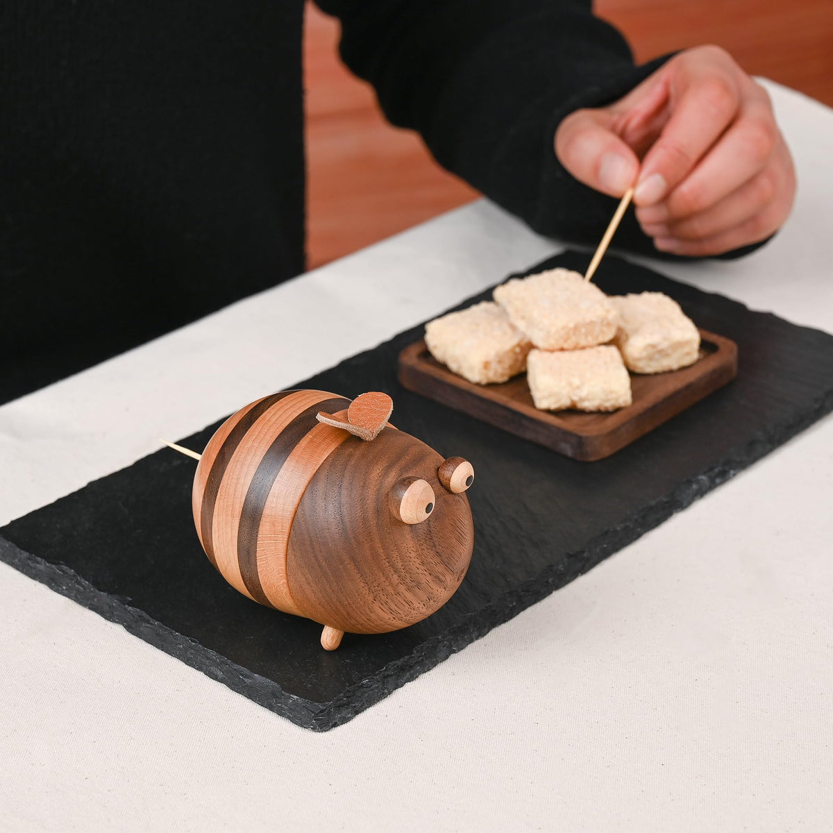 Damuzhi dining table setup with bee dispenser for convenient access.