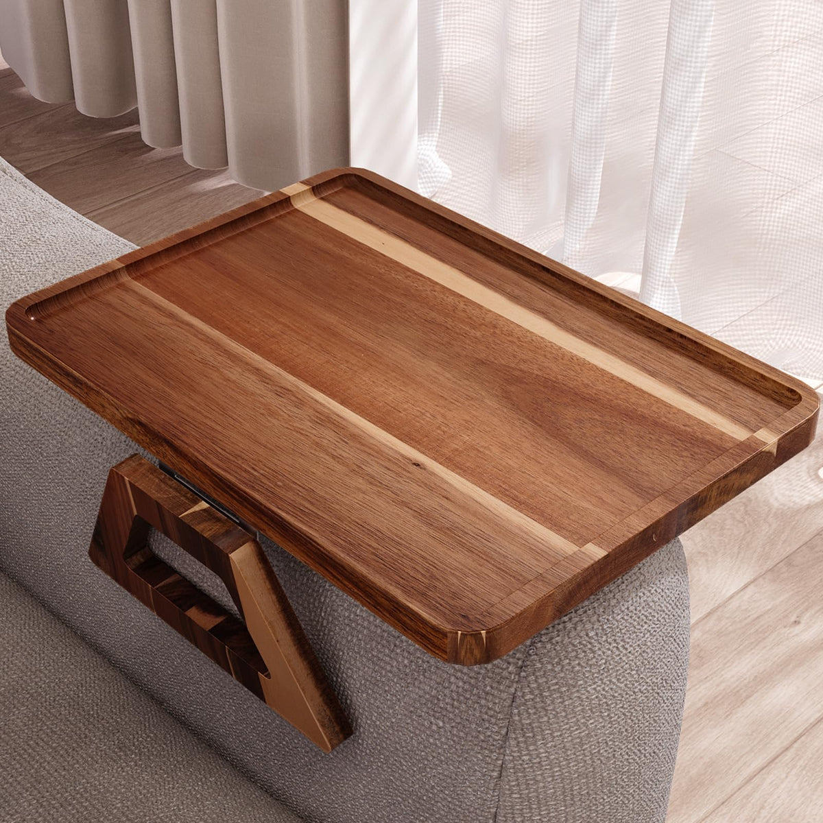 Danfoxer acacia wood couch arm tray on a sofa arm providing a stable surface for drinks