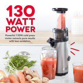 DASH Deluxe compact juicer pouring juice with smooth, pulp-free texture.
