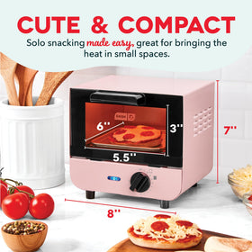 DASH mini toaster oven temperature dial close-up shows adjustable heat for toast and snacks.