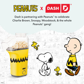 DASH Peanuts Fresh Pop popcorn maker with a bowl of fluffy popcorn.