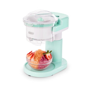 The DASH Shaved Ice Maker on the counter, ready for snow cones and slushies.