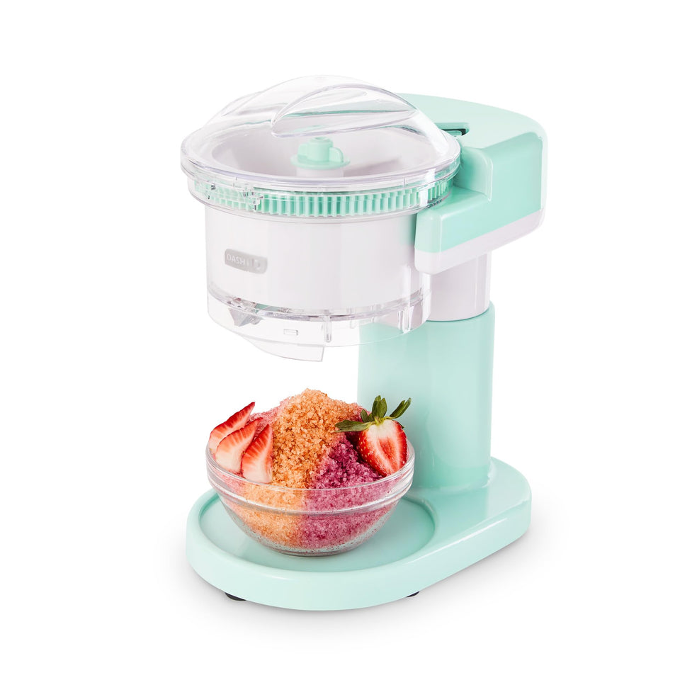 The DASH Shaved Ice Maker on the counter, ready for snow cones and slushies.