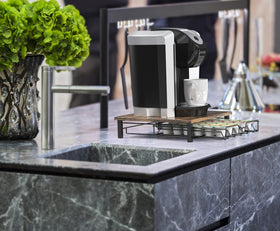 Deco Brothers K-Cup drawer under-machine demonstrates efficient counter organization.