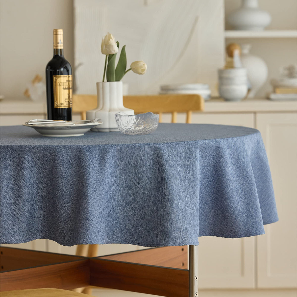 Decorelia denim blue round tablecloth waterproof for outdoor dining and easy cleanup.