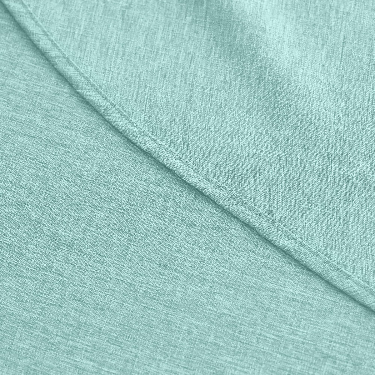 Decorelia farmhouse tablecloth aqua protecting a table surface.