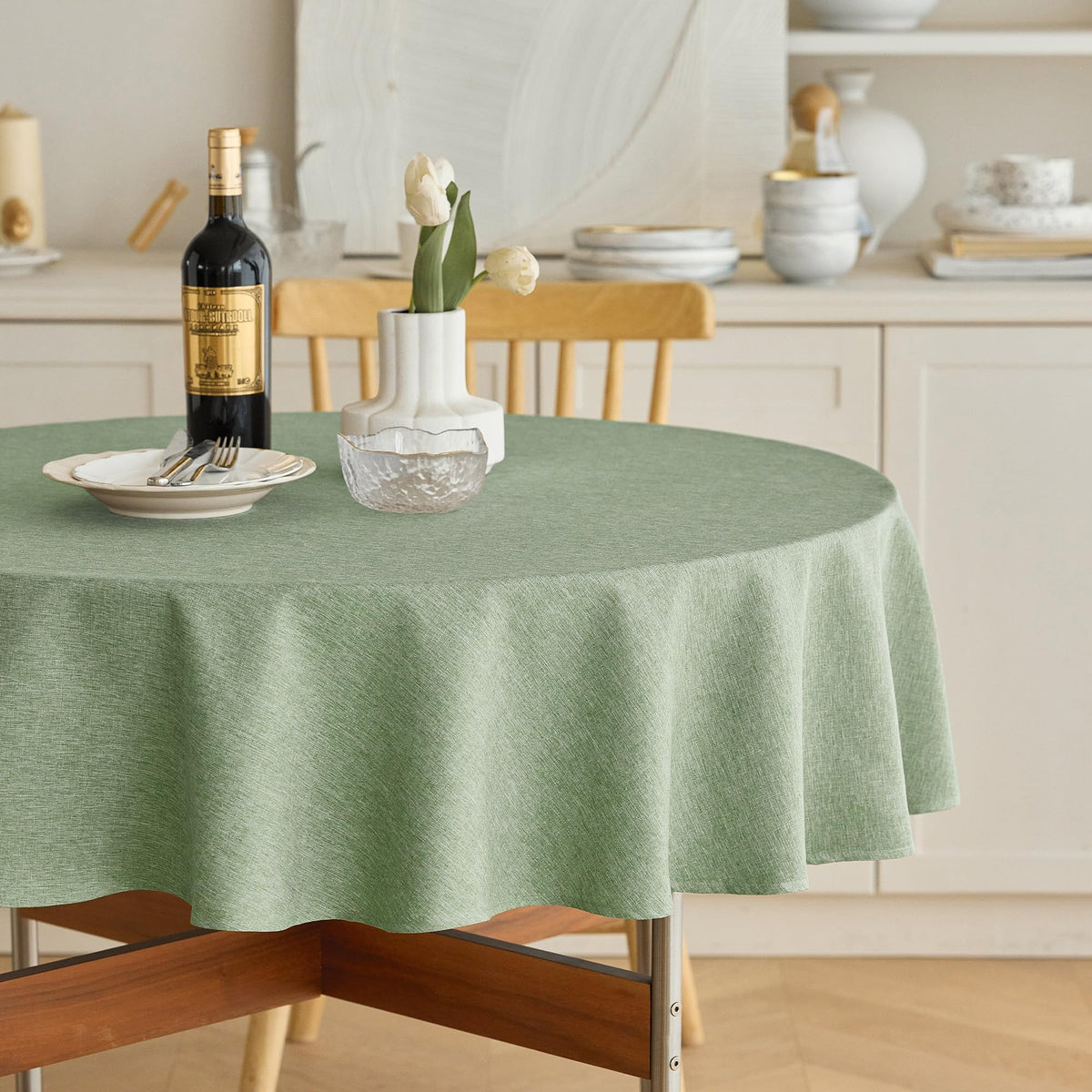 Decorelia faux linen round tablecloth sage green with waterproof protection for spills.