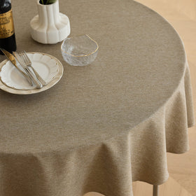 Decorelia faux linen round tablecloth suited for indoor and outdoor dining with rustic charm.