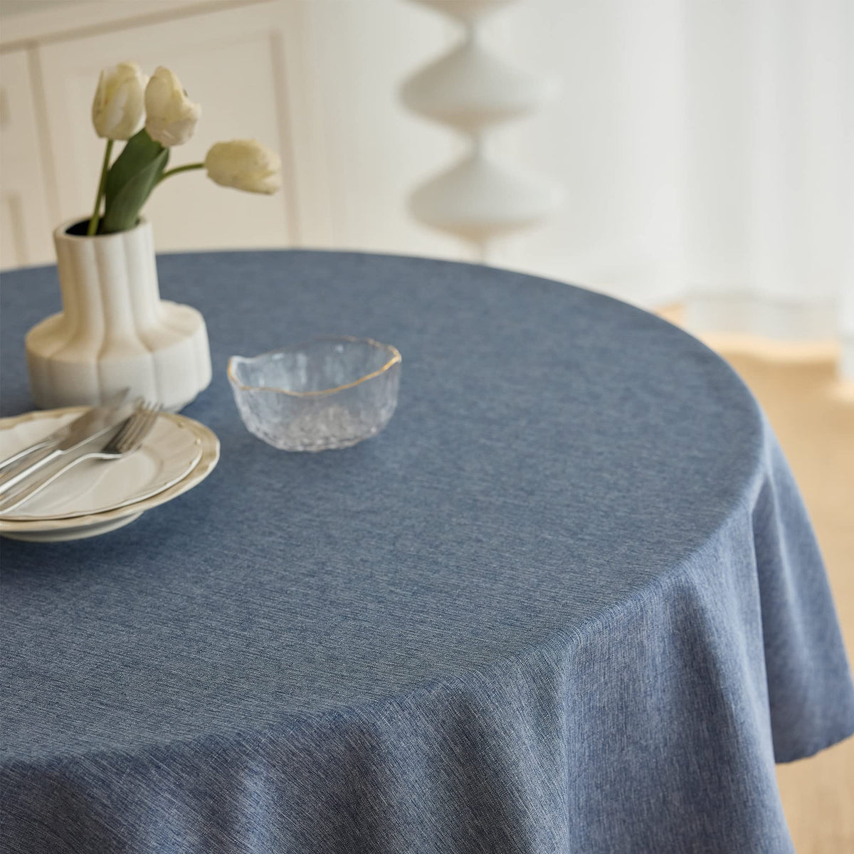 Decorelia faux linen texture round tablecloth adds style while protecting surfaces.