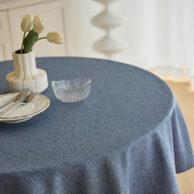 Decorelia faux linen texture round tablecloth adds style while protecting surfaces.