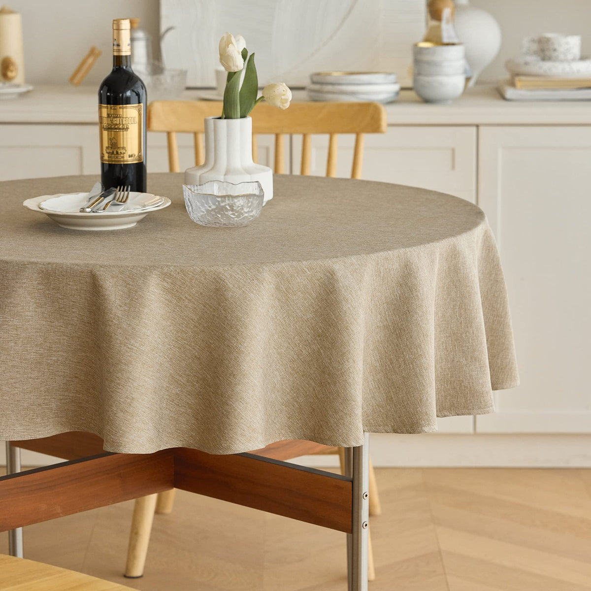 Decorelia waterproof round tablecloth in natural finish keeps 60-inch tables protected.