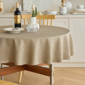 Decorelia waterproof round tablecloth in natural finish keeps 60-inch tables protected.