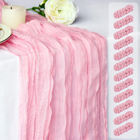 Dekafri pink cheesecloth table runner on a rustic wedding table for soft boho elegance.