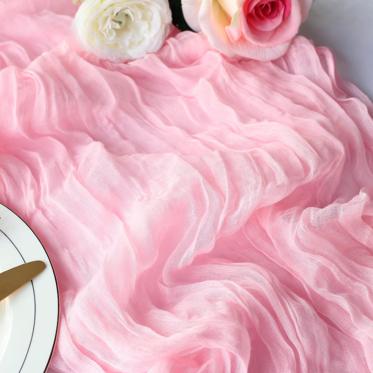 Dekafri pink cheesecloth table runner laid across a buffet to protect surfaces.