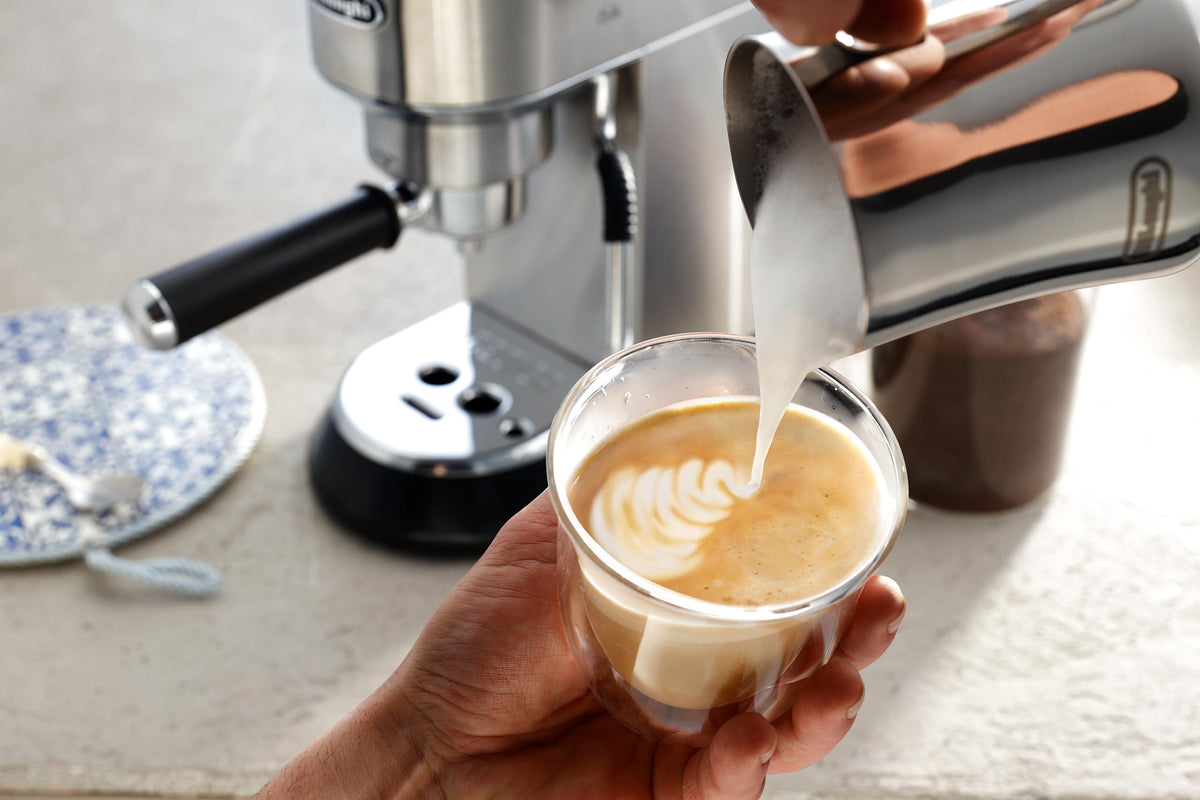De'Longhi stainless steel milk frothing pitcher with ergonomic handle for a safe grip.