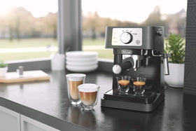 De'Longhi Stilosa tamper, filters, and scoop included for easy setup.
